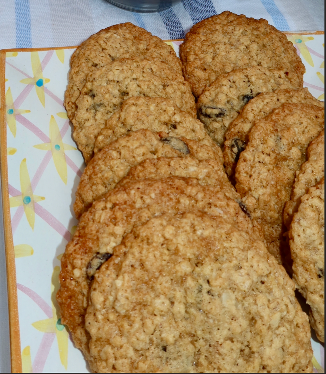 close up of oatmeal cookies on a colorful tray with a striped background